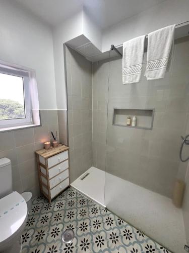 a bathroom with a shower with a toilet and a sink at Toi et Moi Apartments-Guests speek for us! in Ponta Delgada