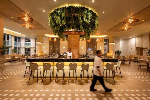 a man walks through the lobby of a restaurant at Riu Ventura - All Inclusive in Cancún
