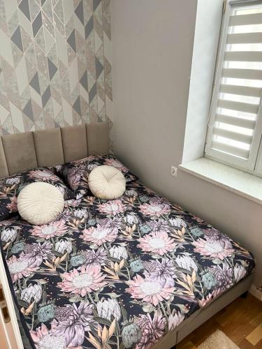 a bed with pillows on it in a room at !! VIP Apartament Pod BIESZCZADAMI !! in Sanok