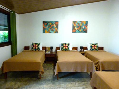 a room with three beds in a room at Primer Canto B&B - Near Ferry & Early Birdwatching Trails in Lepanto