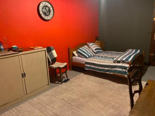 ein Schlafzimmer mit einem Bett und einer Uhr an der Wand in der Unterkunft Suite Étoile in Villebon-sur-Yvette
