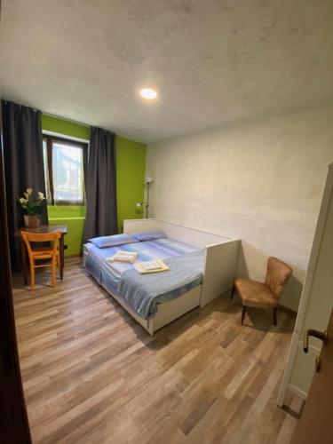 a bedroom with a bed and a table and a chair at CA' DEI PAOLI in Pieve Vergonte