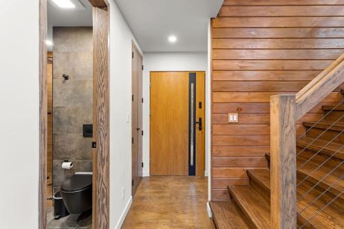 a staircase in a house with wood paneling at Pine Breeze in Pocono Pines