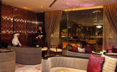 a woman standing in a restaurant with a woman standing in a room at Braira Al Olaya in Riyadh
