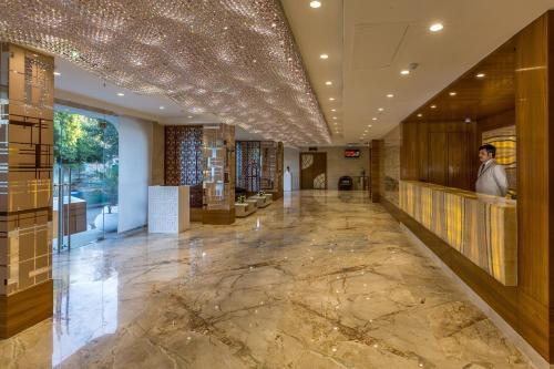 a lobby with a marble floor and a ceiling with lights at Clarks Inn Suites Gwalior in Gwalior