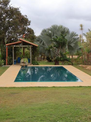 a swimming pool with a gazebo in a yard at Rancho da Montanha Chalé Lua in Resplendor