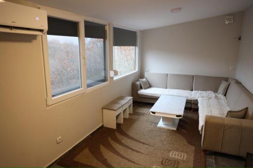a living room with a couch and a table at Villa Taraxha in Mitrovica