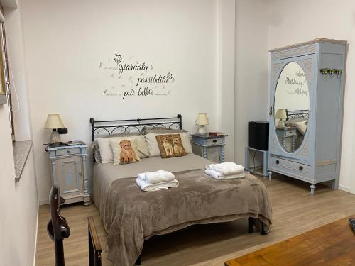 a bedroom with a bed and a large mirror at CASCINA LAI - Oasi Naturalistica - Camere private in Santena