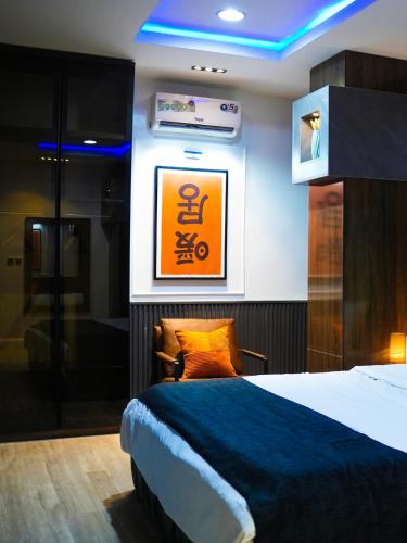 a hotel room with a bed and a sign on the wall at SUITE De PARIS in Abuja