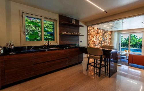 a kitchen with a table and a chair and two windows at Savusavu Sea View in Savusavu