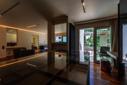 a living room with a glass table in the middle at Savusavu Sea View in Savusavu