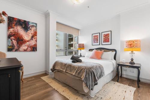 a bedroom with a bed and a painting on the wall at Sydney Harbourside Gem in Sydney