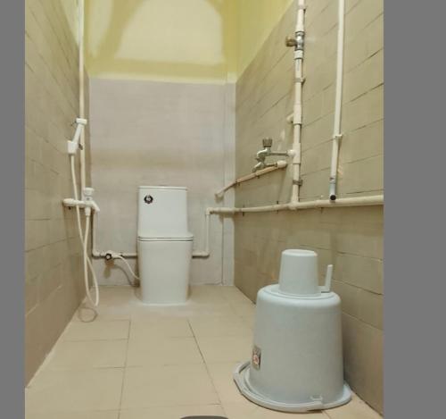 a bathroom with a toilet and a sink at JB lodge in Chidambaram