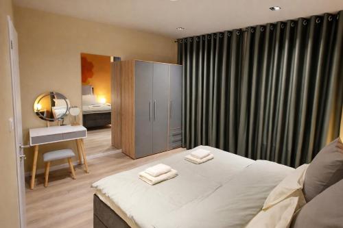 a bedroom with a bed with two towels on it at Casa Mateo - Mediterranean Studio in Bielefeld