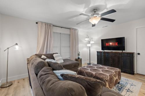 a living room with a couch and a tv at The Tanglewood Upper Suite in Chattanooga