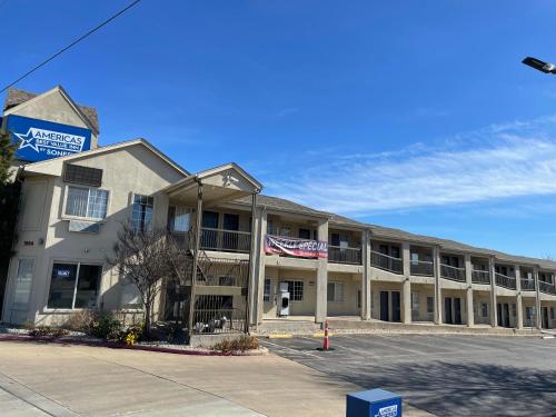 a building with an american flag in front of it at Americas Best Value Inn Arlington in Arlington