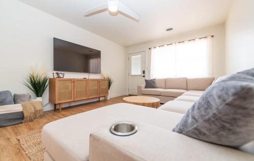 a living room with a couch and a flat screen tv at Newly Remodeled Family Friendly Home in Page