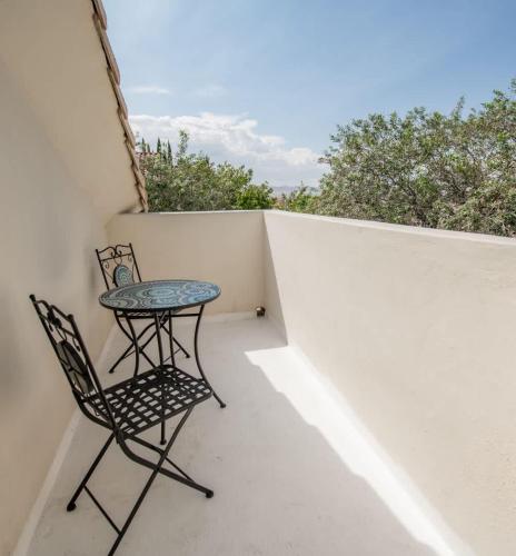 a small table and a chair on a balcony at Large Family Home with Game Room in Page