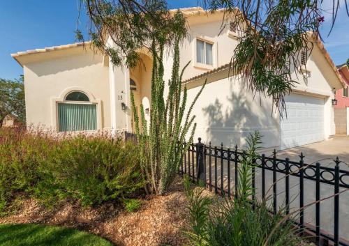 a white house with a black fence at Large Family Home with Game Room in Page