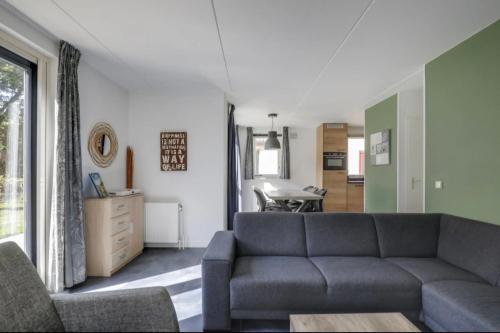 a living room with a couch and a table at Vakantiehuis 6pers op park 't Broeckhuys in Ewijk groot Zwemplas in het land van Maas & Waal niet voor arbeidsmigranten in Ewijk