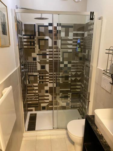 a bathroom with a shower with a toilet and a sink at Casa dell'Orso Biella in Biella
