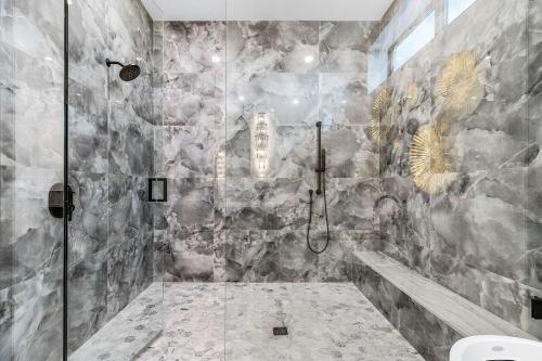 a bathroom with a shower with a stone wall at Oyster Cluster in Fort Myers Beach