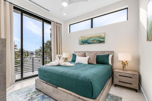 a bedroom with a bed and a large window at Oyster Cluster in Fort Myers Beach