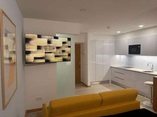a living room with a couch and a kitchen at Hotel Buganvília in Funchal