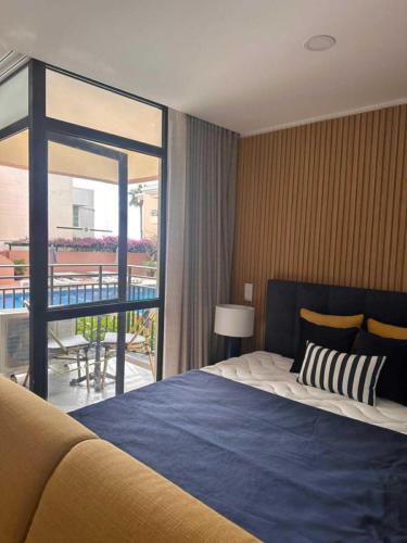 a bedroom with a large bed and a balcony at Hotel Buganvília in Funchal