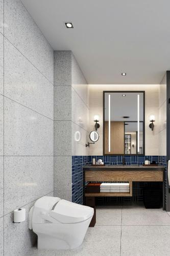 a bathroom with a toilet and a sink and a mirror at Four Points by Sheraton Hefei High-Tech Zone in Hefei