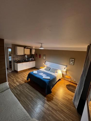 a bedroom with a large bed and a kitchen at Estrada De Benfica 600 Apartamentos in Lisbon