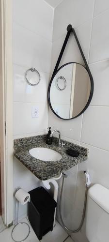 a bathroom with a sink and a mirror at Doce Encanto in Uberaba