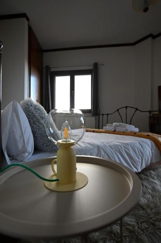 a room with a bed and a table in front of a bed at Valley Parnass in Arachova