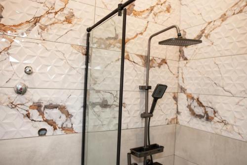 a shower with a glass door in a bathroom at The Maridoc in Lagos