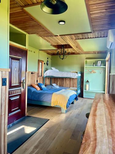 a bedroom with a bed and a wooden ceiling at Panguipulli Bella Vista in Panguipulli