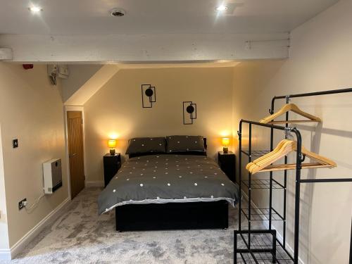a bedroom with a bed and two lights on the wall at Studio 1 in Howden