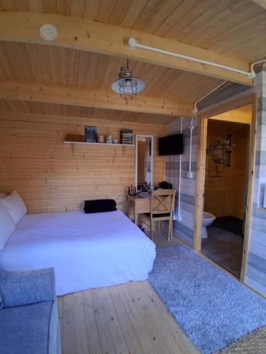 a bedroom with a bed and a desk and a television at Bay Stay in Greenhill