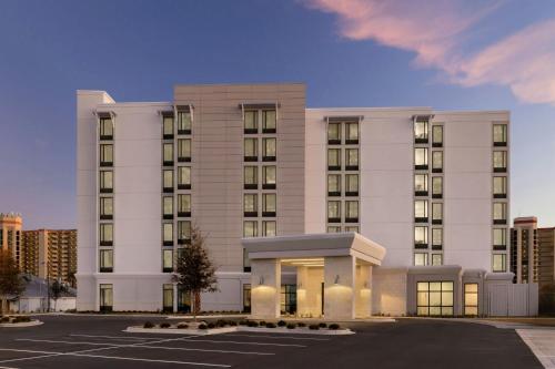 a large white building with a parking lot at SpringHill Suites by Marriott Orange Beach Gulf Shores in Orange Beach