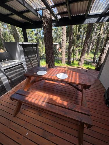 a wooden picnic table on a wooden deck at BOSQUE LIBERTAD Casa Planta Baja in Mar Azul