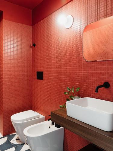 a bathroom with a white sink and a toilet at C’est la vie TAORMINA in Taormina