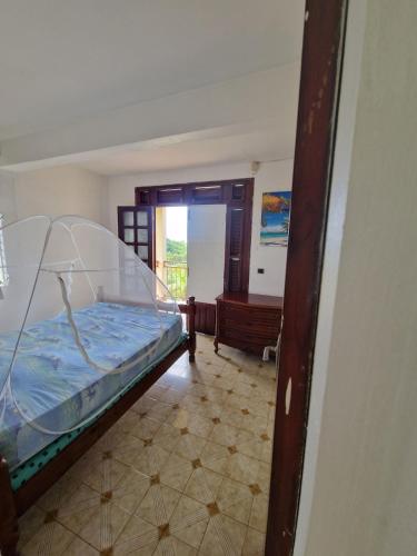 a bedroom with a bed in a room at Holiday rental House in Schœlcher