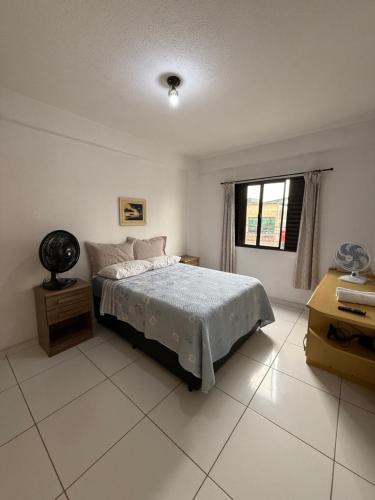 a white bedroom with a bed and a window at SMART FLAT HOTEL apartamento 11A CENTRO in Mogi das Cruzes