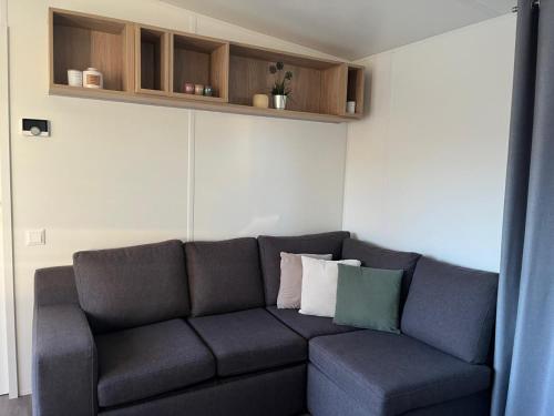 a living room with a couch with pillows on it at Tiny House Beilngries in Beilngries