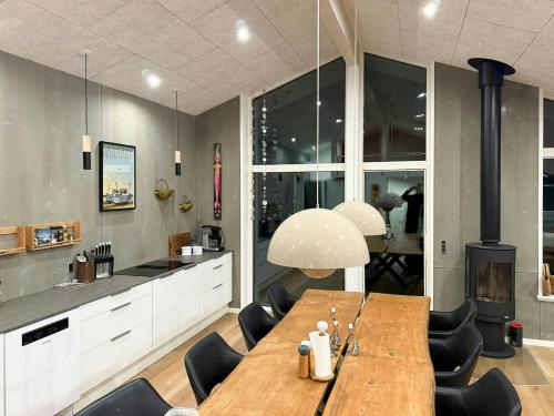 a dining room with a table and a kitchen at Architect-Designed House In Juelsminde in Juelsminde