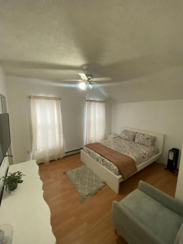 a bedroom with a bed and a ceiling fan at Spacious Private Room with Private Bath in Paterson