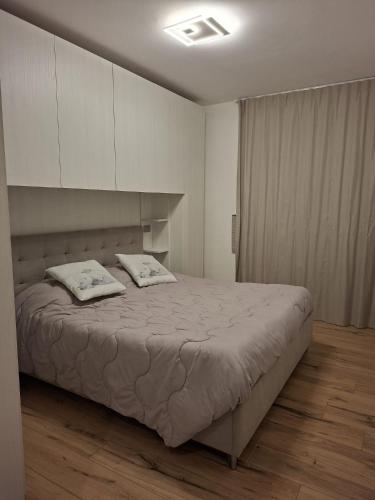 a bedroom with a bed with two pillows on it at La cà de Clüsu in Clusone