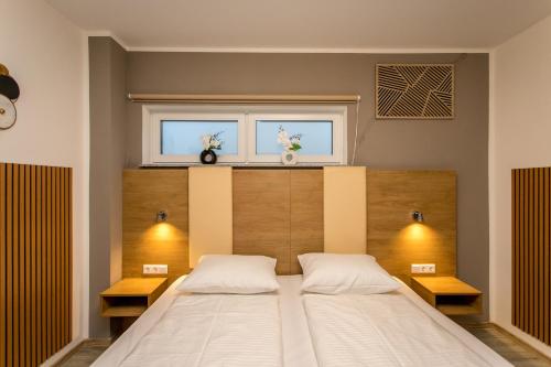 a bedroom with a large bed and two windows at Conco Leipzig in Leipzig