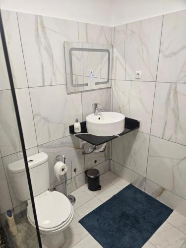 a bathroom with a sink and a toilet and a mirror at I Love Tanque in Caculi