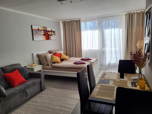a living room with a couch and a table at Bergzauber Bayerwald - voll ausgestattetes Familienapartment mit Pool in Sankt Englmar
