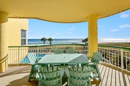 a table and chairs on a balcony with the beach at Beach Colony East Unit 1C in Pensacola